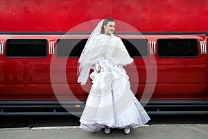 Beauty bride on background red limo car