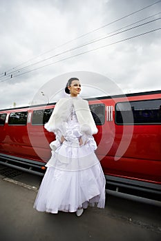 Beauty bride on background red limo car