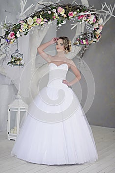 Beauty bride in bridal gown indoors