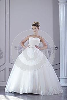 Beauty bride in bridal gown indoors