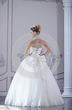 Beauty bride in bridal gown indoors