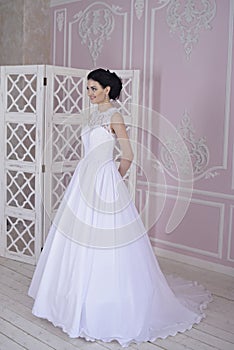 Beauty bride in bridal gown indoors