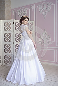 Beauty bride in bridal gown indoors
