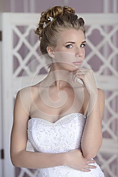 Beauty bride in bridal gown indoors