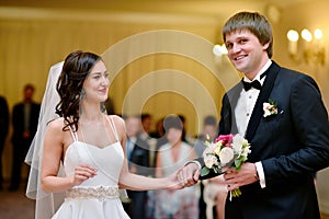 Beauty bride and handsome groom are wearing rings each other