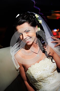 Beauty bride in wedding limousine