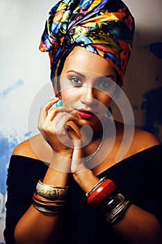 Beauty bright african woman with creative make up, shawl on head