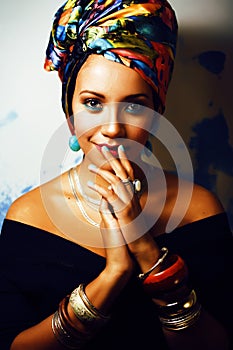Beauty bright african woman with creative make up, shawl on head