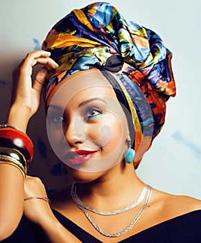 Beauty bright african woman with creative make up, shawl on head like cubian closeup smiling