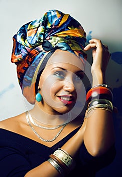 Beauty bright african woman with creative make up, shawl on head like cubian closeup smiling