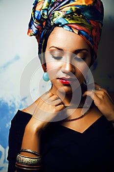 Beauty bright african woman with creative make up, shawl on head like cubian closeup smiling