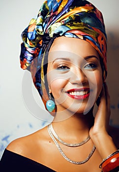 beauty bright african woman with creative make up, shawl on head like cubian closeup smiling