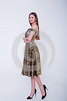 Beauty brunette model woman in cocktail dress. Beautiful fashion luxury makeup and hairstyle. Seductive girl silhouette