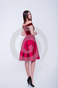 Beauty brunette model woman in cocktail dress. Beautiful fashion luxury makeup and hairstyle. Seductive girl silhouette