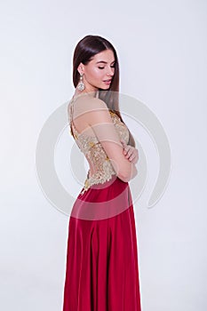 Beauty brunette model woman in evening dress. Beautiful fashion luxury makeup and hairstyle. Seductive girl silhouette