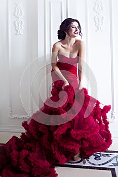 Beauty Brunette model woman in evening red dress. Beautiful fashion luxury makeup and hairstyle, full length