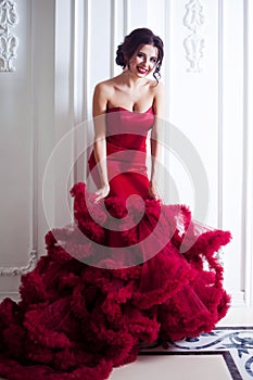 Beauty Brunette model woman in evening red dress. Beautiful fashion luxury makeup and hairstyle, full length