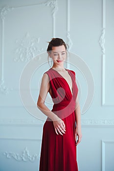 Beauty brunette model woman in evening red dress. Beautiful fashion luxury makeup and hairstyle. Seductive girl