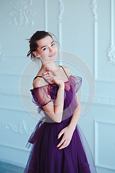 Beauty brunette model woman in evening violet dress. Beautiful fashion luxury makeup and hairstyle. Seductive girl