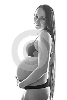 Beauty brunette pregnant woman isolated black and white portrait, tenderness people concept