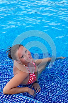 Beauty brunette in tropical pool