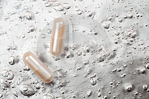Beauty capsule on backdrop with cosmetic oxygen bubbles