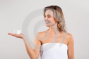 Beauty Care For Aged Skin. Middle Aged Woman Holding Jar With Cream
