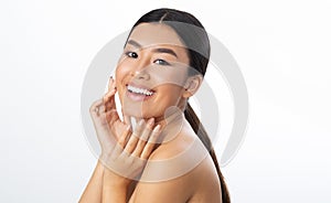 Beauty care. Asian woman touching soft face skin