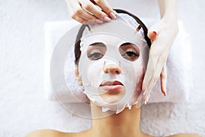 Beauty and Care. Beautiful Young Girl with Mask in Spa Salon. Spa Therapy. High Resolution