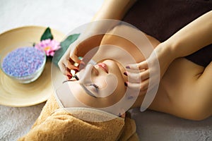 Beauty and Care. Cosmetologist Makes Face Massage. Young Woman L