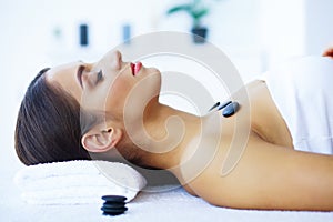 Beauty and Care. Woman in Spa Salon. Young Girl Lying on Massage Tables and Relaxing. Pure Skin and Beautiful Smile