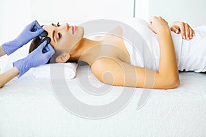 Beauty and Care. Young Girl with Clean Skin in Spa Salon. Woman Relaxing And Lying With Closed Eyes. High Resolution