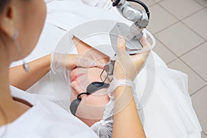 Beauty clinic employee does hair removal using laser