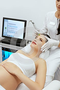 Beauty Clinic. Pregnant Woman Doing Intense Peeling Treatment
