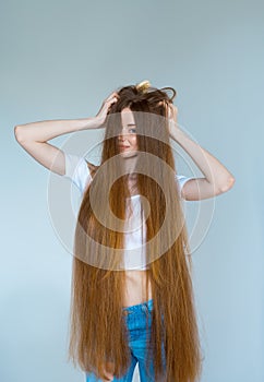 Beauty close-up portrait of beautiful young woman with long brown hair on white background. Hair care concept.