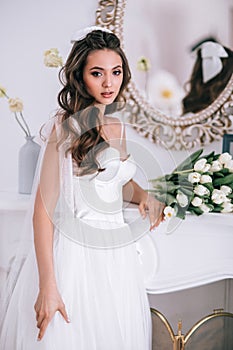 Beauty close-up portrait of bride with luxury make-up and hairstyle, studio indoor photo.