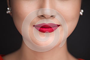 Beauty. Close up view of beautiful woman lips with red matt lips