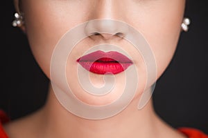 Beauty. Close up view of beautiful woman lips with red matt lips