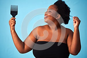 Beauty, comb and black woman with hair care in studio for natural, afro and salon treatment. Cosmetic, health and