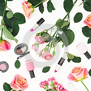 Beauty composition with roses flowers and make up cosmetics on white background. Flat lay, top view.