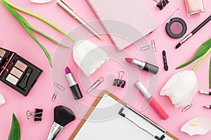 Beauty composition with tulips flowers, cosmetics and accessory on pink background. Top view. Flat lay. Home feminine desk.