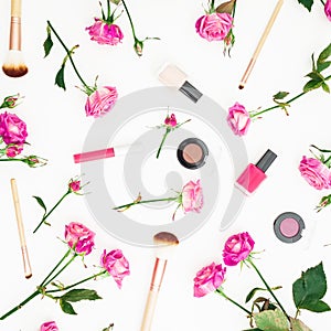 Beauty concept with flowers. Feminine composition with pink roses and cosmetics on white background. Flat lay, Top view.