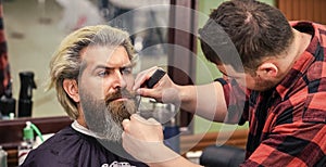 Beauty Concept. making new hairstyle. male hairdresser in workshop. bearded man.