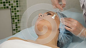 Beauty concept. The mesotherapy procedure in process. beautician holds syringe for injection working with woman`s left