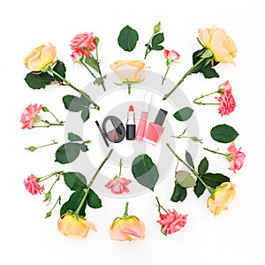 Beauty concept with roses flowers and feminine cosmetics on white background. Flat lay, top view