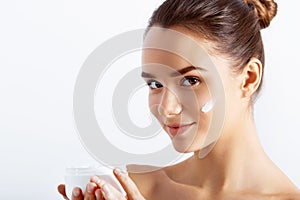 Beauty Concept. Taking good care of her skin. Attractive young woman looking at camera