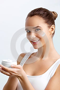 Skincare. Beauty Concept. Young Pretty Woman Holding Cosmetic Cream.Girl wiht fresh skin,