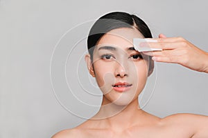 Beauty concept,Young beautiful asian woman with clean and bright skin, Holding a cotton swab to clean the face And skin toner