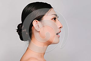 Beauty and Cosmetics Concept-Side face of Youthful pretty young Asian woman on gray background