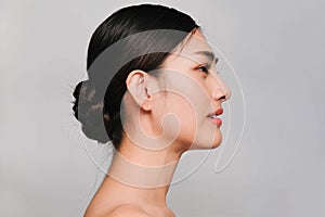 Beauty and Cosmetics Concept-Side face of Youthful pretty young Asian woman on gray background